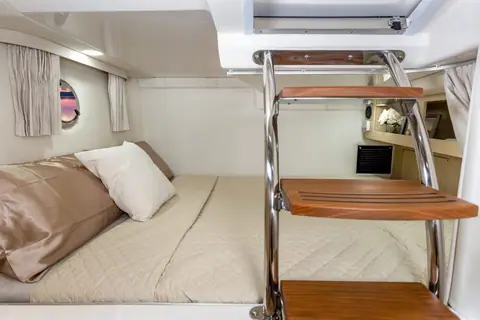 Regal 28 Express cabin with the forward berth and teak companionway steps