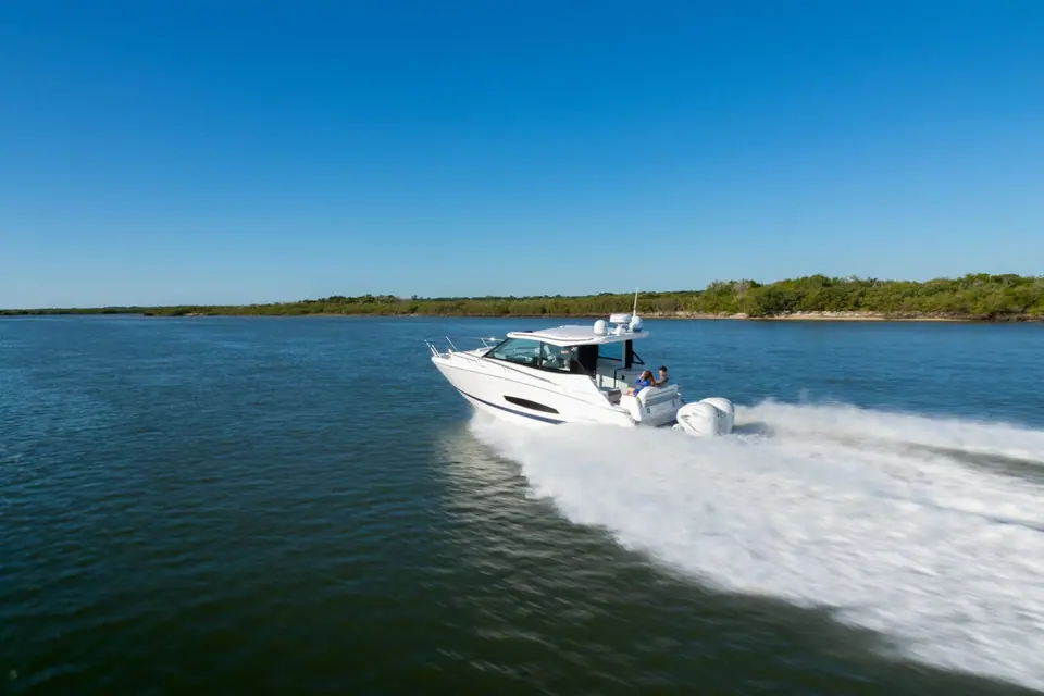 Regal 36 XO seen from the stern quarter at speed showing its twin outboards