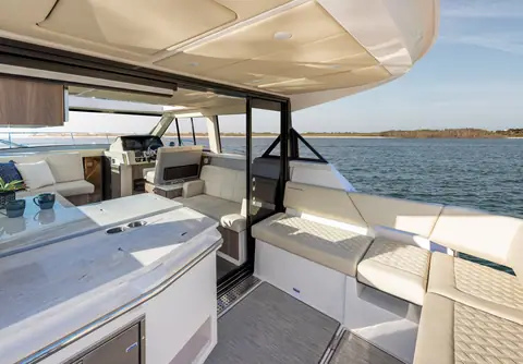 Regal 38 XO main deck looking forward from the galley to the helm and lounge seating