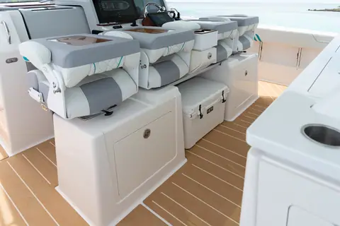 Regal 43 SAV helm deck with three gray bolster seats and teak style decking