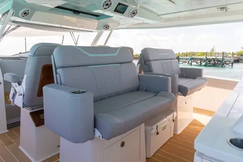 Regal 50 SAV helm deck with gray captain and companion seats under the hardtop