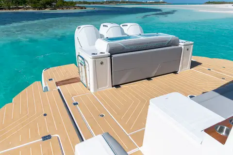 Regal 50 SAV aft deck with teak style flooring and transom seat facing the outboards