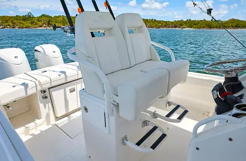 Regulator 23 helm leaning post with fold down bolster seats and twin outboards astern