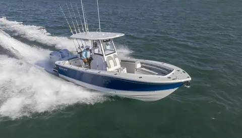 Regulator 25 running at speed with twin outboards and a full rocket launcher of rods