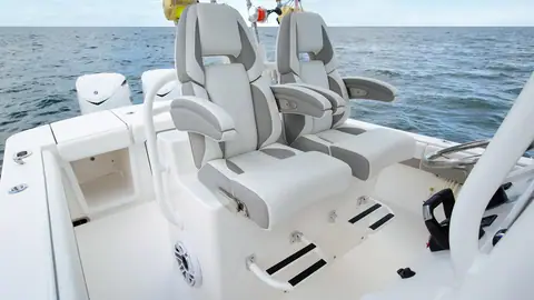 Regulator 28 helm seats with flip up bolsters facing the console and twin outboards