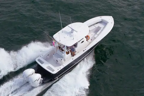 Regulator 31 seen from above running at speed with twin outboards and an open cockpit