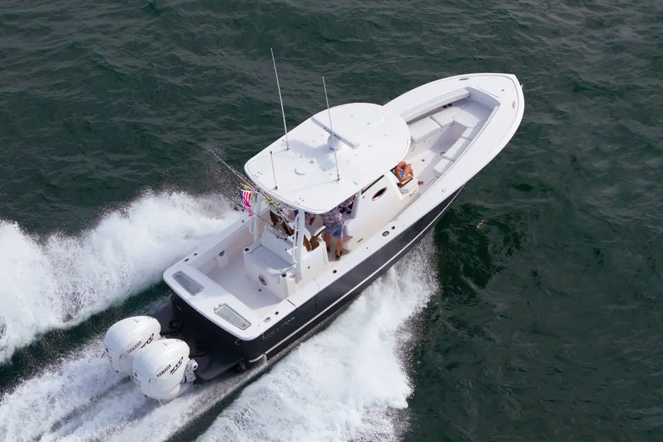 Regulator 31 seen from above running at speed with twin outboards and an open cockpit