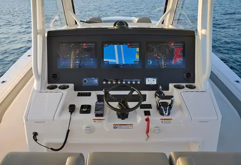 Regulator 37 helm console with three Garmin displays, wheel and engine controls