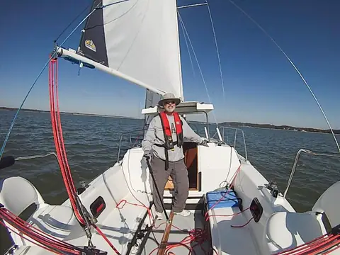 Rhodes 22 cockpit seen from the bow with a sailor standing in the companionway