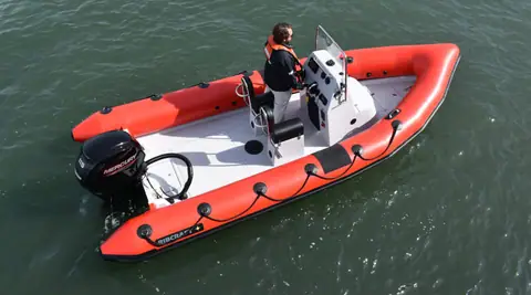 Overhead view of a red RIBCRAFT 5.85 showing the center console, seat and open deck