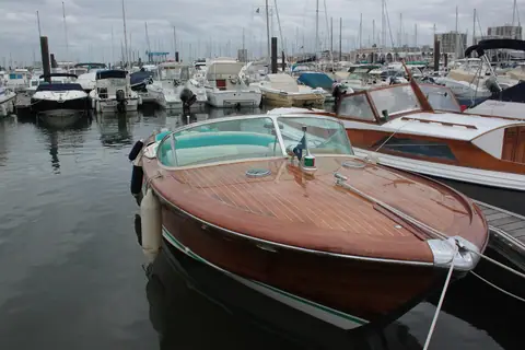 Varnished mahogany Riva Aquarama in a crowded marina in Arcachon