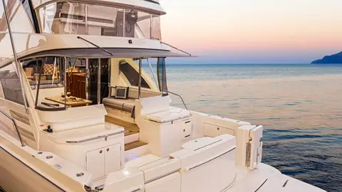 Riviera 50 Sports Motor Yacht cockpit and aft galley opening into the saloon at dusk