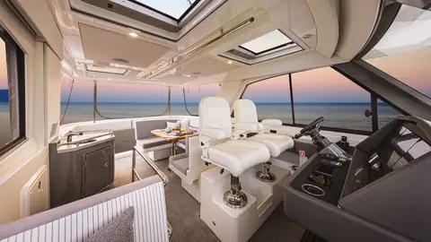 Riviera 50 Sports Motor Yacht enclosed flybridge with twin helm chairs and lounge