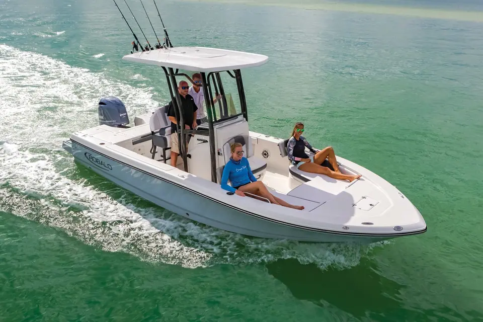 Robalo 226 Cayman cruising over green shallows with guests on the bow seats