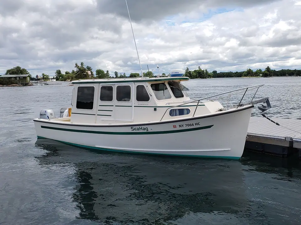 Rosborough RF 246 tied to a dock showing its pilothouse, cabin windows and bow pulpit