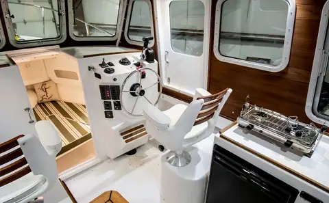 Rosborough 246 Halifax pilothouse with helm seat, wheel, stove and steps down to the cabin