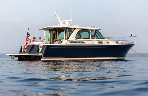 Sabre 45 Salon Express at anchor in profile with guests in the cockpit