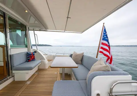 Sabre 45 Salon Express cockpit with L shaped settee and table under the hardtop overhang