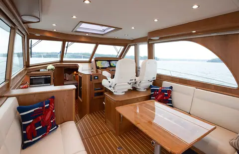 Sabre 45 Salon Express salon with dinette, galley and twin helm chairs forward