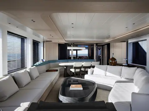 Sanlorenzo SD118 main salon by Liaigre with white sofas and a dining table aft