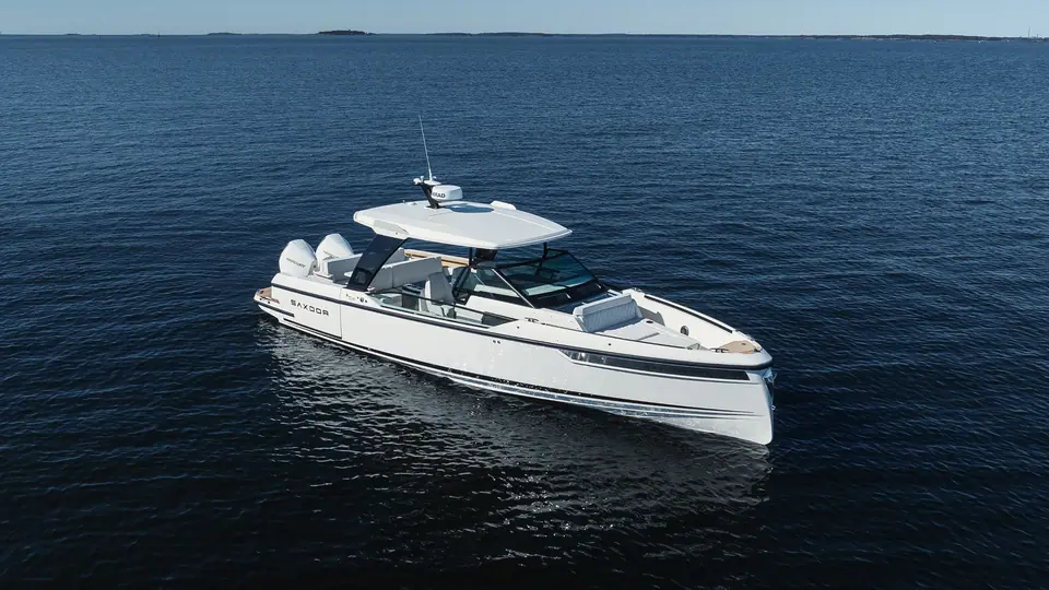 Saxdor 320 GTO idling on dark open water seen from the bow quarter