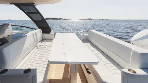 Saxdor 320 GTO aft cockpit with facing settees and a long folding table