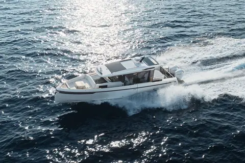 Saxdor 340 GTWA running at speed on twin outboards with its walkaround side decks