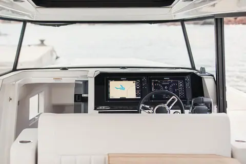 Saxdor 340 GTWA wheelhouse helm with twin displays and a wheel behind the windscreen