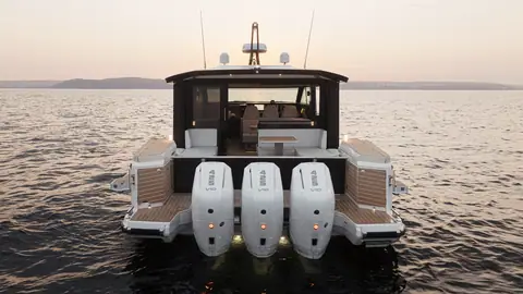 Stern of the Saxdor 460 GTC with triple Mercury outboards and the aft cockpit