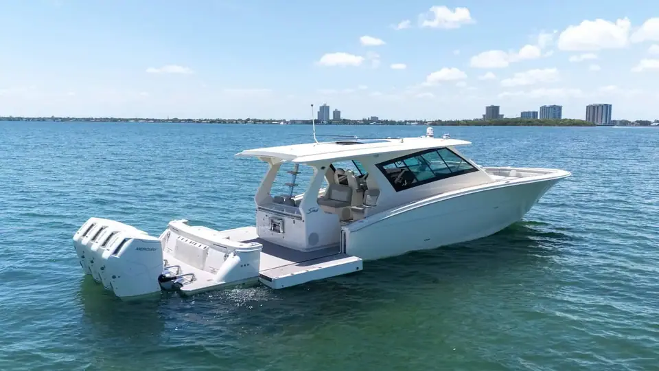 Scout 530 LXF at rest from the stern quarter showing quad outboards and the aft deck