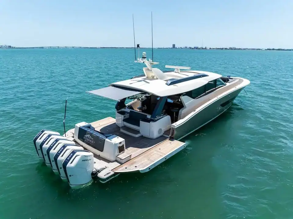 Scout 670 LXS at anchor with the aft beach platform lowered and a row of outboards