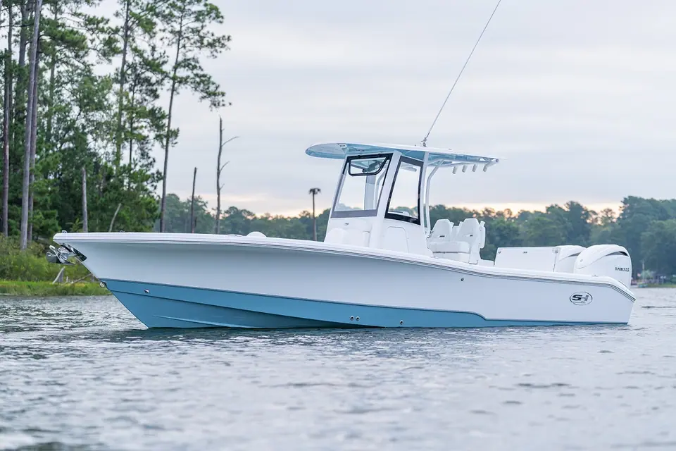 Sea Hunt BX28 bay boat at rest in profile with a light blue hull