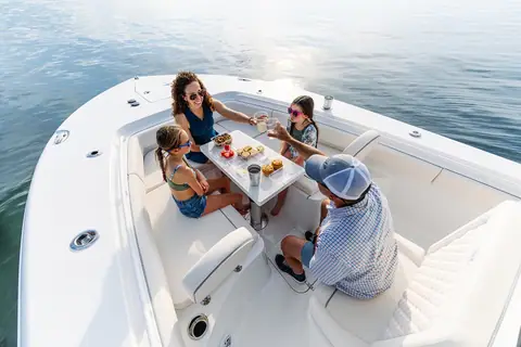 Family at the bow table of the Sea Hunt Gamefish 27FS forward seating