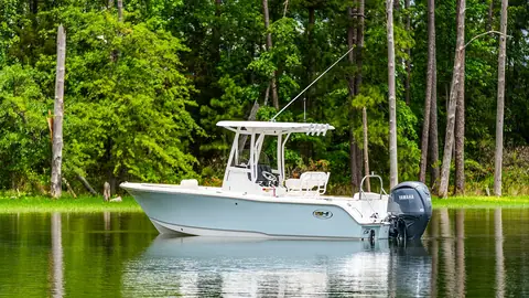 Sea Hunt Ultra 229 center console at rest on calm water
