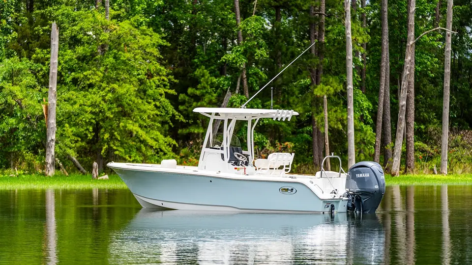 Sea Hunt Ultra 229 center console at rest on calm water