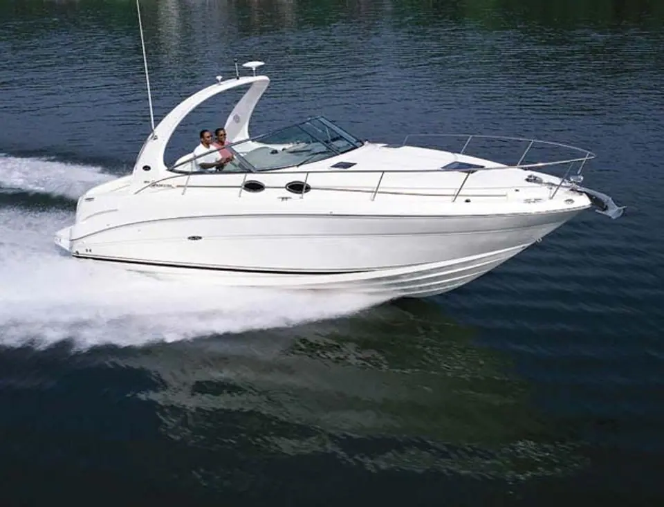 Sea Ray 300 Sundancer running across calm water with its radar arch and windshield