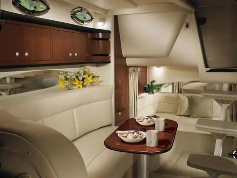 Sea Ray 300 Sundancer cabin with a cream dinette, cherry table and forward berth