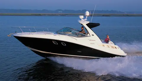 2007 Sea Ray 310 Sundancer with a black hull and radar arch running at speed