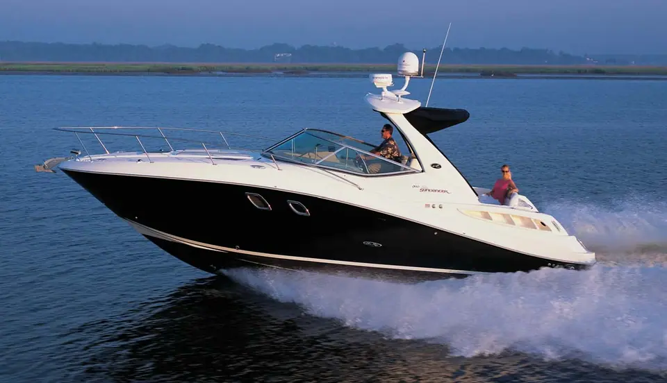 2007 Sea Ray 310 Sundancer with a black hull and radar arch running at speed