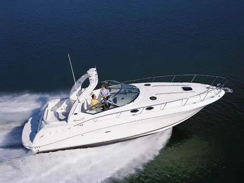 Aerial view of a white Sea Ray 340 Sundancer running fast with its radar arch