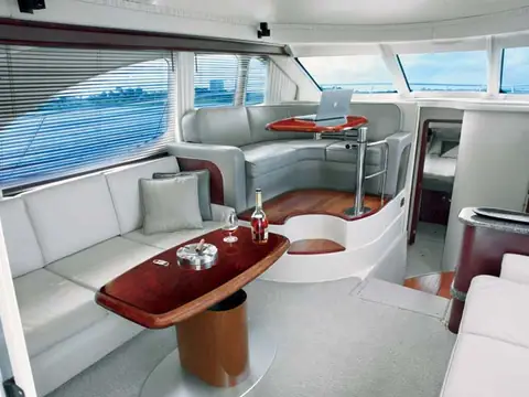 Sea Ray 44 Sedan Bridge salon with gray leather seating and a cherry cocktail table