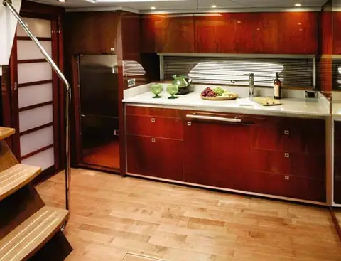 Sea Ray 470 Sundancer galley with cherry cabinets and a light wood sole