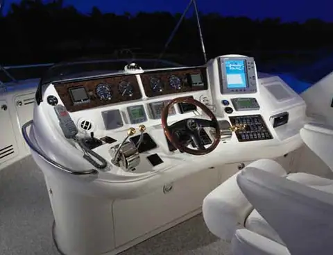 Flybridge helm of the Sea Ray 480 Sedan Bridge with wood wheel and gauges