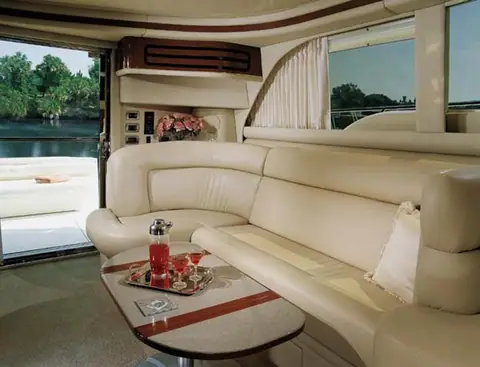 Main salon of the Sea Ray 480 Sedan Bridge with an L shaped leather settee