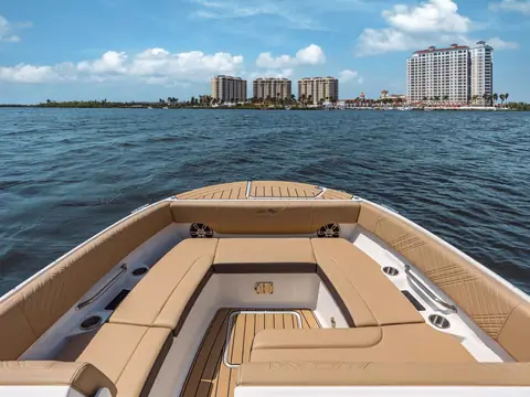 Bow lounge seating of the Sea Ray SDX 270 with teak style flooring