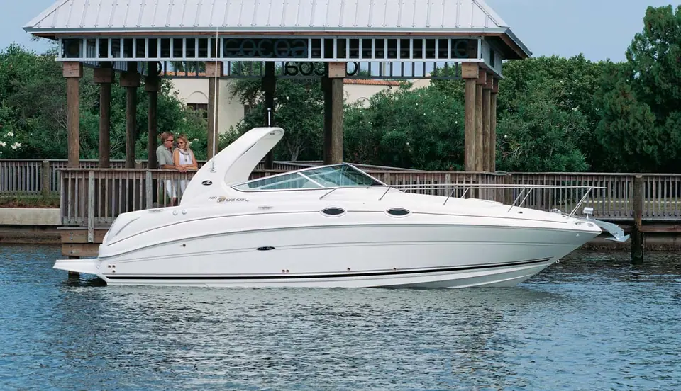 2007 Sea Ray 280 Sundancer in profile beside a waterfront pavilion