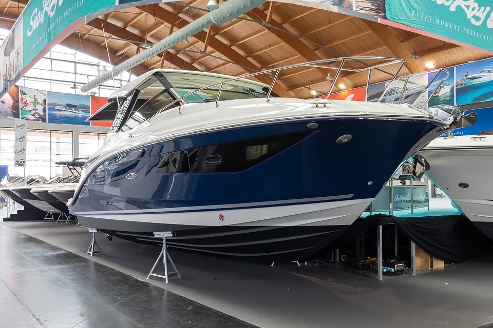 Bow of a blue Sea Ray Sundancer 320 at a boat show
