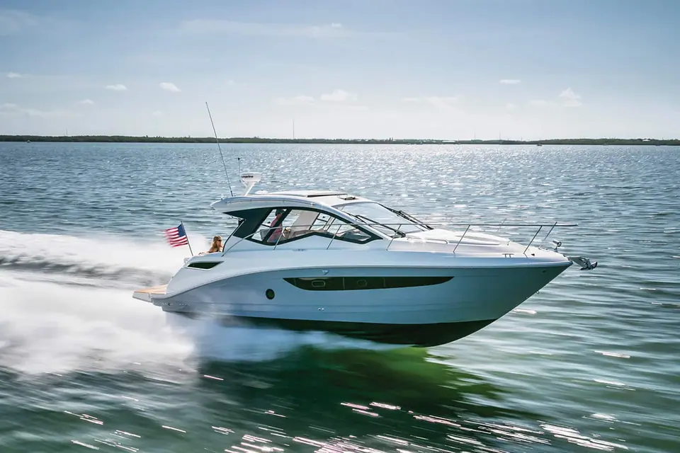 Sea Ray Sundancer 350 Coupe cruising in profile on open water