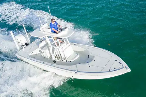 SeaVee 270Z running over green water seen from the bow with an angler at the console