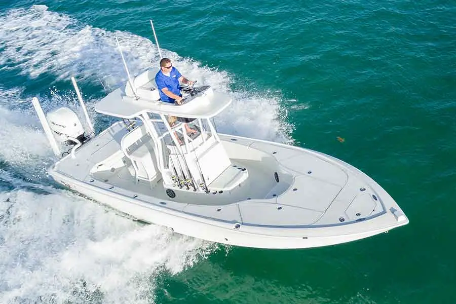 SeaVee 270Z running over green water seen from the bow with an angler at the console